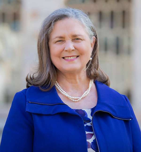 Portrait of Jan Love with the grand windows old Theology Building in the background